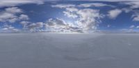 3d snow scene of the sun over the snowy fields of an icy mountaintop with mountains and clouds