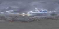 the reflection of clouds and water on a wall camera roll over a beach, with waves splashing against them