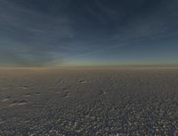 a sky view of snowy plains covered in snow on a sunny day with bright blue skies