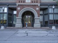 an entrance to the building and two parking spaces with a red fire hydrant next to it