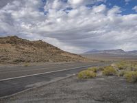 the road through the desert is deserted and deserted in all its glory as it winds into the middle east