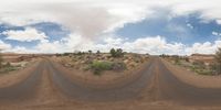 dirt roads in desert with clouds and blue sky overhead to depict climate change and weather