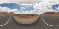 dirt roads in desert with clouds and blue sky overhead to depict climate change and weather