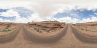 dirt roads in desert with clouds and blue sky overhead to depict climate change and weather