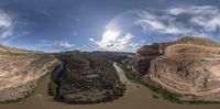 the sky is clear and clear with clouds overhead a canyon of water below is an artificial waterway