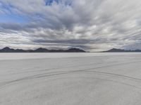 a photo of the white desert with two tires on it in the foreground of the photograph