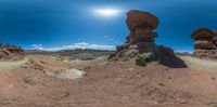 the image is looking straight ahead, it has a mountain in the background and an orange rock structure