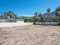 a vacant lot in palm springs that is being used as land where two homes are parked