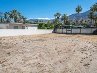 a vacant lot in palm springs that is being used as land where two homes are parked