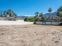 a vacant lot in palm springs that is being used as land where two homes are parked