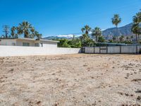 a vacant lot in palm springs that is being used as land where two homes are parked