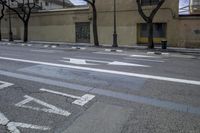 a person is crossing the street in front of an old building and cars on the street