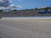 the green road and orange and white stripe line at an event near the racetrack and stadium