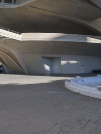 an image of the underside of the building of a building in barcelona, spain with concrete floors and arches