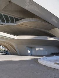 an image of the underside of the building of a building in barcelona, spain with concrete floors and arches