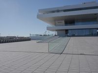 a very large building sitting next to some stairs in front of it by the water