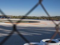 the green road and orange and white stripe line at an event near the racetrack and stadium