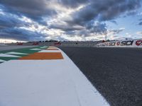 there is a colorful road on this side of the street on the race track under cloudy skies