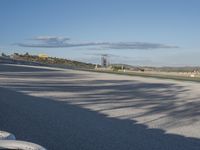 the green road and orange and white stripe line at an event near the racetrack and stadium