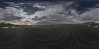 the view of the sun setting over a race track from a 360 - lens perspective