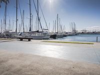 there is a boat dock where many boats are docked and one is empty in the water