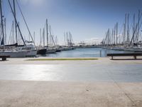 there is a boat dock where many boats are docked and one is empty in the water