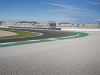 the green road and orange and white stripe line at an event near the racetrack and stadium