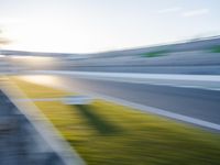 a blurred image of a track with a speed flag and a sky background at sunset