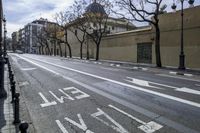 a person is crossing the street in front of an old building and cars on the street