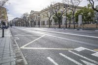 a person is crossing the street in front of an old building and cars on the street