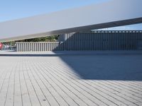 a bricked - in walkway outside of a building with a sky background that is partially empty