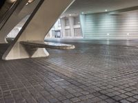 the person is standing near a building that has a stone floor and there are multiple rectangular shapes