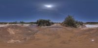 a very big wide angle shot of the road on a dirt field with a full moon in the sky