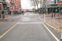 a sidewalk with pedestrians and walking people in it on a rainy day near some tall buildings