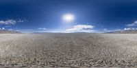 there is a very long desert landscape with a lone person on the horizon in the distance