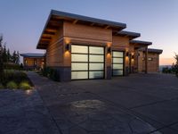 an image of a beautiful house at sunset outside the night time's lights in the door