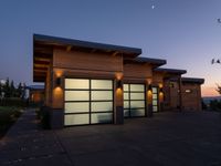 an image of a beautiful house at sunset outside the night time's lights in the door