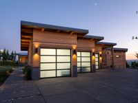 an image of a beautiful house at sunset outside the night time's lights in the door