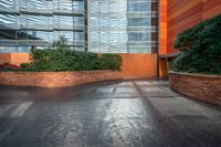 a woman walks up a concrete walkway outside a building at night with sunlight pouring in through windows