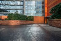 a woman walks up a concrete walkway outside a building at night with sunlight pouring in through windows