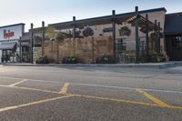 a store front with wood privacy screens and a car parked outside it, on the street side