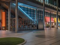 the courtyard of the building is lit up by brightly lit lighting that can be seen at night