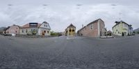 a street view with an upside down fish eye lens and a person walking on the sidewalk