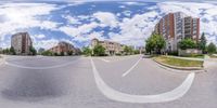 a large wide view of buildings and the street from an angle perspective on a spherical lens