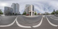 a view of an empty city street from the outside while it's cloudy and sunny