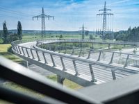 view out the window on an elevated roadway with power lines in the distance on a sunny day