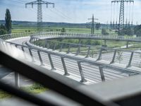 view out the window on an elevated roadway with power lines in the distance on a sunny day