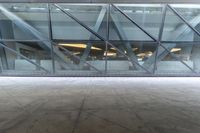 the view from the outside of a building through a glass walkway of a red suitcase