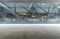 the view from the outside of a building through a glass walkway of a red suitcase