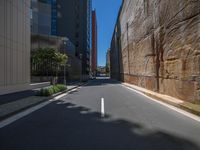 the view of a narrow street between two tall buildings on the side walk of the street